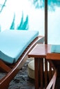 Close up. Wooden beach bed poolside oriental tropical style. High angle view Royalty Free Stock Photo