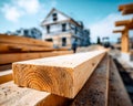 Close-up of wooden beam at a construction site with a house in the background Royalty Free Stock Photo