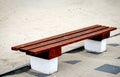 Bench surrounded by sand on the esplanade footpath near the sea . Resting place on the beach