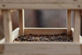 Wooden Birdhouse with Mix of Seeds Royalty Free Stock Photo