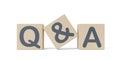 Close up of wooden blocks with the letters q and a on white background, question and answer business concept, selective focus