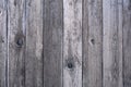 Close-up of a wooden board fence with time-faded boards and cracks Royalty Free Stock Photo