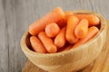 Close up of wooden bowl filled with delicious Baby Carrots Royalty Free Stock Photo