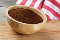 Close up of a wooden bowl of Fresh Ground Coffee