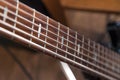 Close-up of a wooden brown guitar neck and strings. Concept shop of musical instruments, concert, bard, kvartirnik Royalty Free Stock Photo