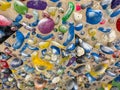 CLOSE UP: Wooden climbing wall is filled with colorful holds covered in chalk.