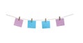 Wooden clothes pins with blank blue and pink paper hanging on brown rope isolated on white background Royalty Free Stock Photo