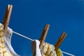 Close-Up of Wooden Clothespins Holding Clothes on Clothesline Royalty Free Stock Photo