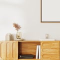 Close up of Wooden cupboard with books and decor with corner of an empty frame on white wall, interior details, 3d