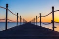 Close up ,a wooden dark bridge near the sea at bright orange sunset,backgound,texture,wallpaper, amazing romantic view, a path Royalty Free Stock Photo