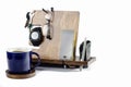 Close-up of wooden desk organizer with pencil and watch, computer, pen and book lying on the desk