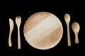 Close up wooden dish ,spoon,fork and knife on black background Royalty Free Stock Photo