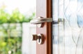 Close-up wooden door opening with blur garden background