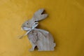 Close up on a wooden easter bunny on a yellow tablecloth with copy space Royalty Free Stock Photo