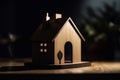 Close-up of a wooden figure of a small one-story house. A miniature statuette made of light wood stands on a table in Royalty Free Stock Photo