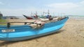 Close up of wooden fishing boats and nets on beach in Weligama, Sri Lanka.