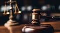 Close up of a wooden gavel in a courtroom with the scales of justice blurred in the background, symbolizing law, order, and Royalty Free Stock Photo