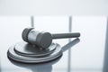 Close up of wooden gavel on light desk with reflections. Law, justice and judgement concept. Royalty Free Stock Photo