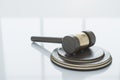 Close up of wooden gavel on light surface with reflections and mock up place. Law, justice and judgement concept. Royalty Free Stock Photo