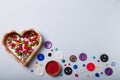 Wooden heart shaped box of multicolored beads and buttons for sewing and embroidery. Set of materials for handcraft