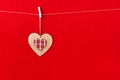 Close up of wooden heart simbol on red paper background