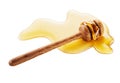 Close-up of wooden honey dipper on white