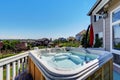 Close-up of wooden hot tub. Luxury house exterior.