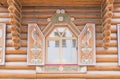 Close up of wooden house - open window with carved colorful shutters. Traditional russian terem