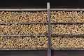 Close-up of wooden house walls with shelves holding firewood in Haanja, Estonia