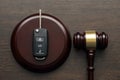 Close up of wooden judge gavel and car keys over soundboard on white background Royalty Free Stock Photo