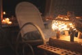 Close-up wooden lampshade with backlight and rocking chair in a poorly lit bedroom at night. Home comfort concept
