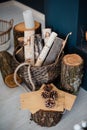 Close up of wooden logs, basket and candles at room