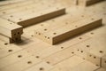 Close up of wooden parts in in big furniture manufacturing facility. Wooden parts for the production of chairs in the