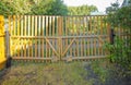 Close-up of a wooden picket fence gate in the backyard of a country house, a sunny summer day Royalty Free Stock Photo