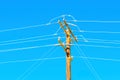 Close-Up of Wooden Power Pole and Wires Against Blue Sky Royalty Free Stock Photo