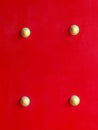 Close up of wooden red gate or door with gold rivet or button of Chinese shrine or temple