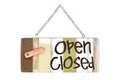 Close up of a wooden sign select open or closed with chain on white background