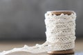 Close up wooden spool with white lace. space for text