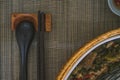 Close-up of wooden spoon and chopsticks next to a rattan rice bowl, inside is a traditional Vietnamese lunch, rice, soup, salty Royalty Free Stock Photo