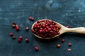 Pink peppercorn in wooden spoon studio shot Royalty Free Stock Photo