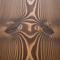Close-up of a wooden surface displaying distinctive grain patterns and knots. The Royalty Free Stock Photo