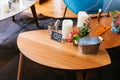 Close up Wooden table with words `Order and Pay at Bar Please` in french dessert cafe