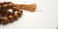 Close up Wooden Tasbih, Islam People prayer bead at white Background with negative space for text placement area