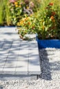 Close-up, wooden terrace and flower bed, selective focus. Vertically