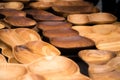Close up of wooden utensils for the kitchen, bowls, plates on dark background. Concept of natural dishes, a healthy lifestyle.