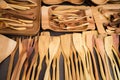 Close up of wooden utensils for the kitchen, bowls, spoons, forks on dark background. Concept of natural dishes, a healthy