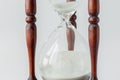 Close up wooden and white sand of vintage hourglass on white background, time concept. Royalty Free Stock Photo