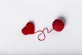 Close up of a wool ball and heart shape on white background. Heart shaped woolen yarn. Love Crochet.