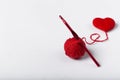 Close up of a wool ball and heart shape on white background. Heart shaped woolen yarn. Love Crochet.