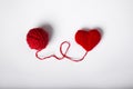 Close up of a wool ball and heart shape on white background. Heart shaped woolen yarn. Love Crochet.